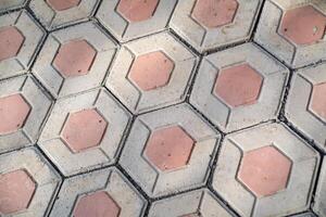 Textured backgrounds hexagonal paving blocks. Hexagonal bricks for flooring exposed to morning sunlight. Texture and Details. Bricks and blocks are made from cement. Negative Space photo