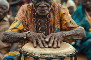 An old man playing a drum in front of a crowd photo