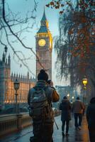 A man taking a picture of a clock tower photo