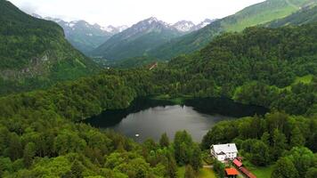 Drone views of Freibergsee and Heini-Klopfer- Schkiflugschanze in Bavaria, Germany. Surrounded by mountains and forests, this pristine lake and famous ski jump is an aerial view of area. Oberstdorf. video