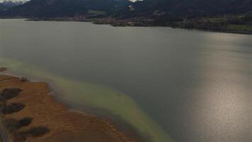 A stunning aerial view of Tegernsee in Bavaria, Germany, during spring. The scene captures the charm of the Bavarian Alps, with its crystal-clear lake, traditional villages, and a peaceful atmosphere video