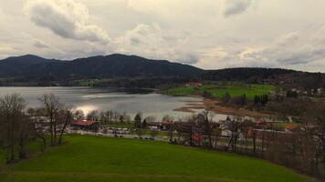 A stunning aerial view of Tegernsee in Bavaria, Germany, during spring. The scene captures the charm of the Bavarian Alps, with its crystal-clear lake, traditional villages, and a peaceful atmosphere video