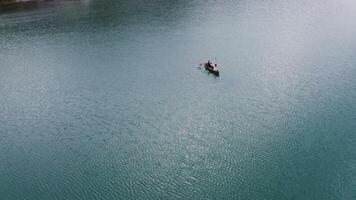 An aerial view of a man in a boat on a lake photo