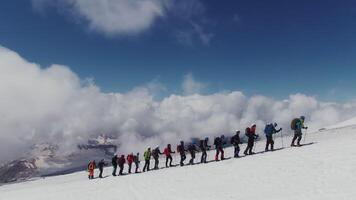 A group of people standing on a snowy mountain photo