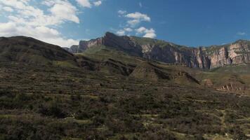 A mountain range with a valley in the background photo