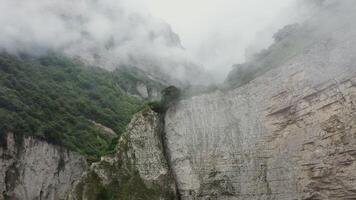 A mountain with a waterfall and a cliff photo