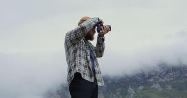 A man taking a photo of a mountain