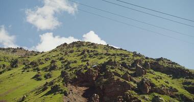 A mountain with a green grassy hill photo