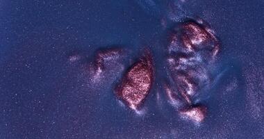 A close up of a rock with a red spot on it photo