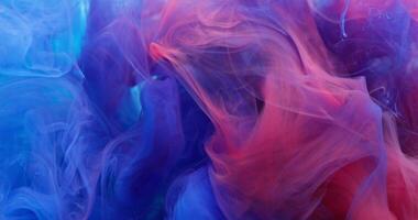 Two bright colors of paint flow, blend, creating abstract patterns photo