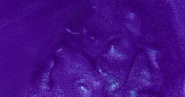 A purple liquid with a white background photo