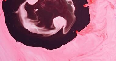 A pink and black swirl on a surface photo