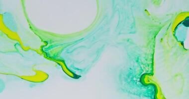 A painting of green and yellow paint on a white surface photo