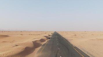 A long empty road in the middle of the desert photo