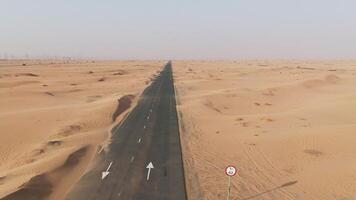 A long empty road in the middle of the desert photo