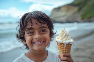 A young boy smiles while holding an ice cream cone photo