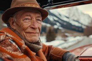 An older man in a hat and sweater driving a car photo