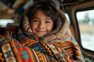 A young girl wrapped in a blanket photo