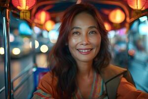 A woman smiles while riding a tuk tuk photo