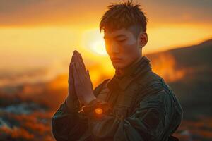 A man in military uniform is praying photo