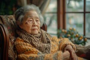 An elderly woman sitting in a chair photo