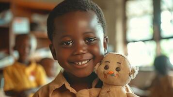 A young boy smiles while holding a stuffed animal photo