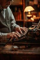 A man sitting at a desk typing on a typewriter photo