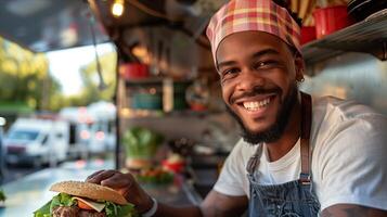 A man is smiling while holding a burger photo