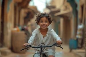 A young boy smiles while riding a bike in an alley photo