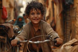 A young boy smiles while riding a bicycle in a city photo