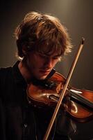 A man playing the violin in a dark room photo