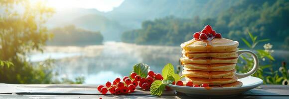 Stack of pancakes with berries on top of a cup photo