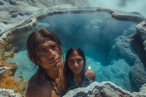 Two people taking a selfie in a hot spring photo