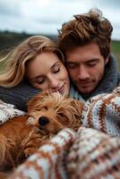 A man and woman are laying on a blanket with a dog photo