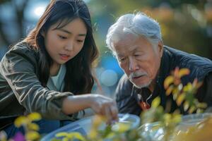 An older man and woman looking at plants in a park photo