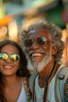 An older man and woman are smiling and wearing sunglasses photo