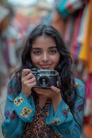 A woman holding an old camera in front of a market photo