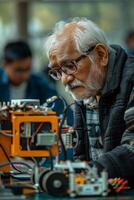An elderly man working on a robot photo