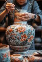 A woman is painting a vase photo