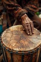 A man's hand is touching a drum photo
