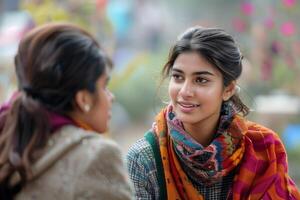 Two young women talking to each other in a park photo