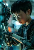 A young boy with a robotic arm working on a machine photo