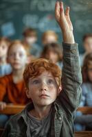 A boy raising his hand in front of a classroom photo