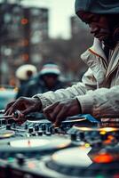 A man in a hoodie is playing a dj photo