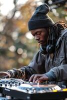 A man with headphones on playing music photo