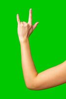 Hand gesture signaling excitement in front of a vibrant green background during a lively event photo
