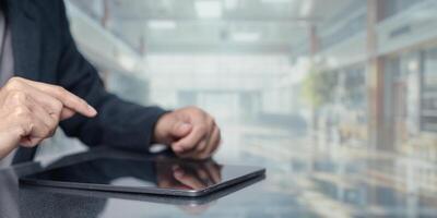 Person Using Tablet in Modern Office Environment with Blurred Background photo