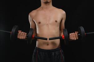 Man Holding Dumbbells to Enhance Build and Strength in Fitness Routine photo