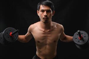 Focused Man Lifting Dumbbells to Build Strength and Improve Health photo