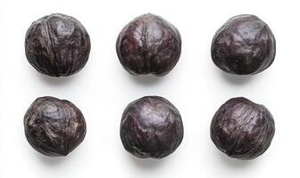 Closeup View of Six Dark Brown Seeds on White Background photo